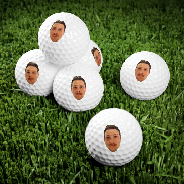 Josh Allen Face Golf Balls in grass.