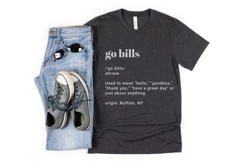 Go Bills definition tee in dark heather gray paired with gray sneakers, light wash jeans and black aviators. 