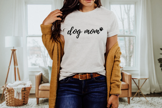 Dog mom tee in white paired with dark wash jeans and a mustard long sweater.
