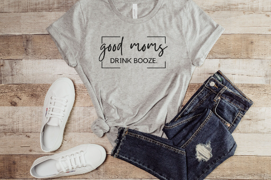 Good Moms tee in ash paired with medium wash jeans and white sneakers.