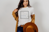 "Ma Bruh" t-shirt in white paired with dark jeans, a tan hat and a mustard sweater.