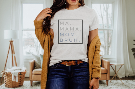 "Ma Bruh" t-shirt in white paired with dark jeans, a Calvin Klein belt and a mustard sweater.